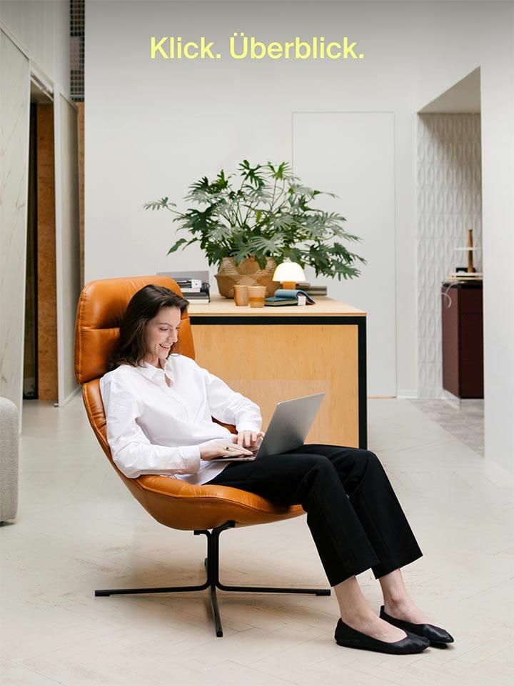 Woman works relaxed on her laptop in the living room