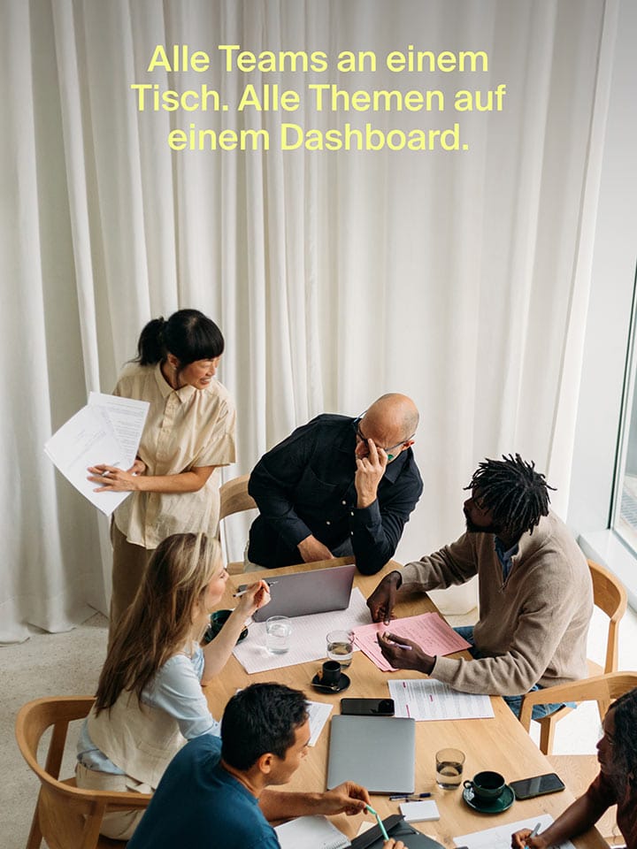 Team works on a shared dashboard project at a conference table