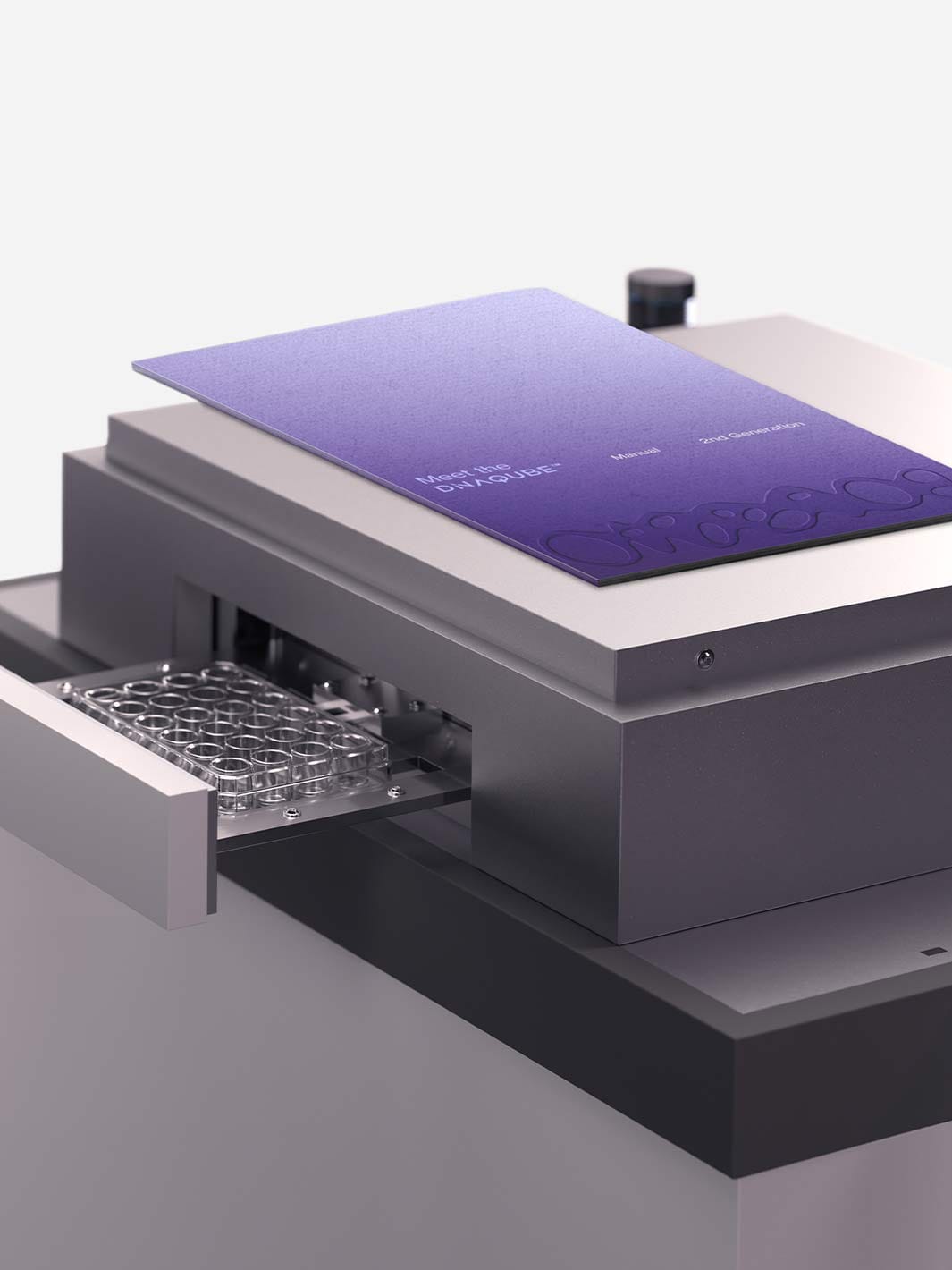 Violet DiNABIOS handbook lying on the DiNAQUBE lab instrument with an open sample drawer