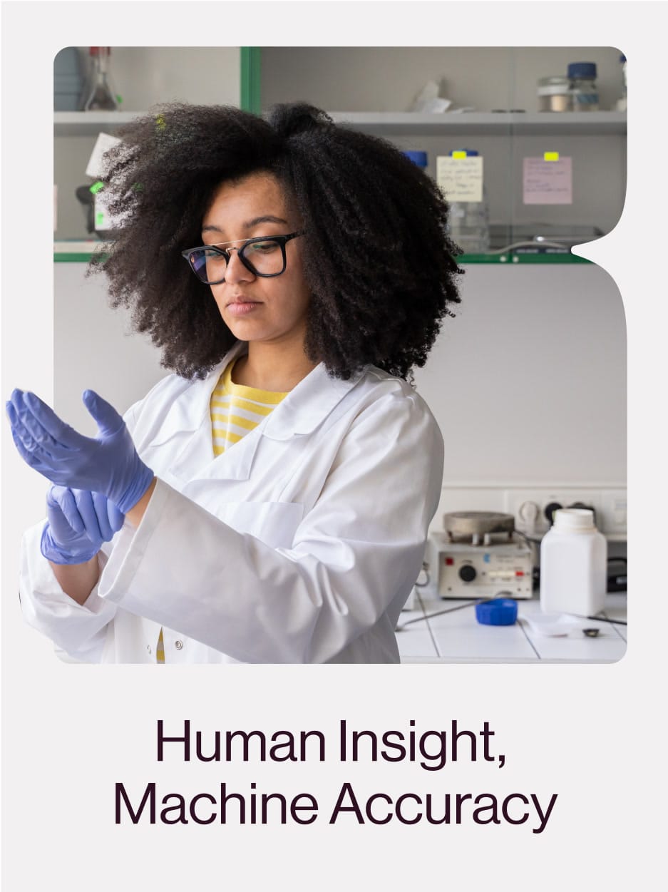 Researcher putting on gloves in the lab: “Human Insight, Machine Accuracy”