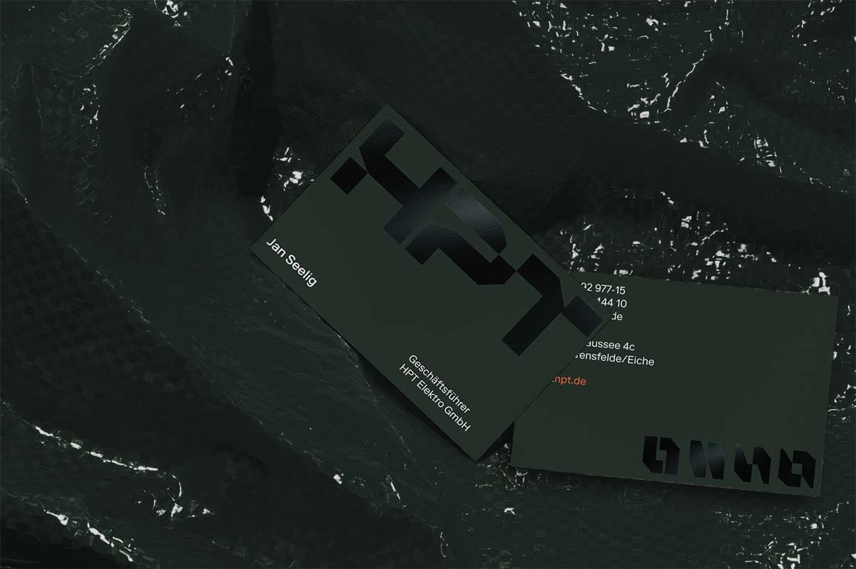 Dark green HPT business cards on black crumpled foil