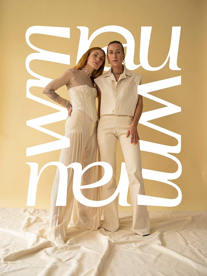 The two founders in cream clothes in front of a golden backdrop, framed by the large rauwm lettering