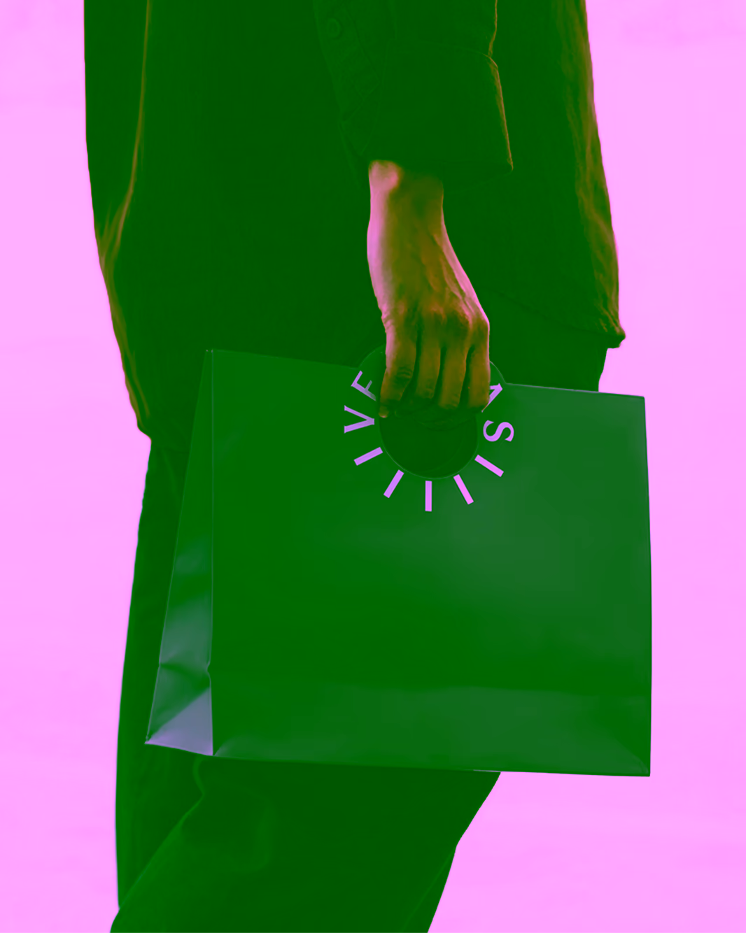 A person carrying a purple VERITAS paper bag